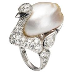 A BUNDA 'Swan' ring in platinum, featuring an exquisite, baroque Cultured South Sea Keshi Pearl, champagne in colour with a clean skin and an excellent lustre. The Swan itself features a round brilliant cut diamond pave set body with bezel set pear and marquise diamonds. Dimensions of pearl: 15.80-21.80mm Characteristics of pear shaped diamonds: 2 = 1.13ct, D-F colour, SI1 clarity. Characteristics of marquise diamonds: 2 = 0.49ct, F colour, VS clarity. Characteristics of round brilliant cut diam Van Cleef And Arpels Jewelry, Van Cleef And Arpels, Pearl And Diamond Ring, Kesha, Yoko London, Color Champagne, Ladies Diamond Rings, Sea Pearl, South Sea Pearls