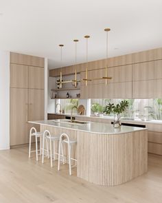 a kitchen with wooden cabinets and white stools