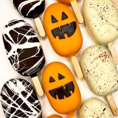 an assortment of halloween themed treats on sticks