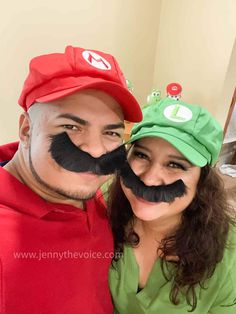 a man and woman with fake moustaches on their faces posing for the camera