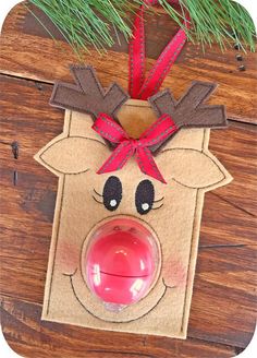 a reindeer ornament hanging from a christmas tree with a red nose and antlers on it's head