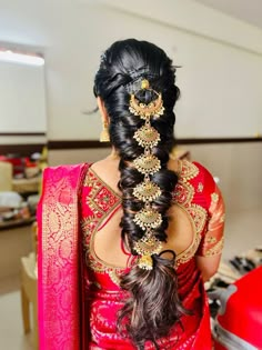 a woman with long hair in a red sari