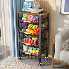 a cart with food and drinks on it next to a couch in a living room