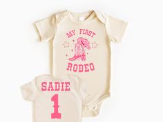 My First Rodeo Baby Bodysuit, Rodeo Birthday, Baby Bodysuit, First Birthday Outfit, Birthday Girl Shirt, First Birthday Shirt, Girl Birthday 💗  Welcome to The WildflowerbyMiley Etsy Shop!  This listing is for the bodysuit, sweatshirt or t-shirt only. All other items that are shown in our photos such as shoes, hats, beanies, blankets etc. are for photo staging purposes and are NOT INCLUDED in the sale. DESCRIPTION:  This baby and children's unisex essential fits like a well-loved favorite. Super First Rodeo Outfit Girl, Dolly Disco, Dino Ranch Birthday, Babyque Shower, First Rodeo Shirt, Pregnant Aesthetic, Smash Cake Photo Shoot, My First Rodeo Birthday, Dino Ranch