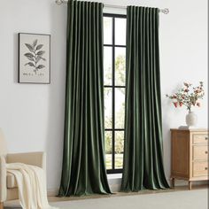 a living room with a large window covered in green curtains