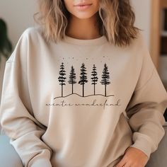 "Step into a world of serene beauty with our minimalist Winter Wonderland sweatshirt. This elegantly designed piece captures the essence of a tranquil winter landscape.  The simplicity of this design speaks volumes, making it a versatile addition to your winter wardrobe. Whether you're sipping cocoa by the fire or taking a brisk walk in the snow, this sweatshirt is your perfect companion. These garments are made from polyester and cotton. This combination helps designs come out looking fresh and beautiful. The collar is ribbed knit, so it retains its shape even after washing. There are no itchy side seams on these sweaters.  .: 50% cotton, 50% polyester .: Medium-heavy fabric (8.0 oz/yd² (271.25 g/m .: Loose fit .: Sewn-in label .: Runs true to size Please be sure to check color and size b Relaxed Fit Sweater For Winter Gift, Cricut Sweatshirt Ideas Women, Minimalist Sweatshirt, Sweater Designs, Winter Retreat, Brisk Walk, Cute Christmas Sweater, Minimalist Winter, Cottagecore Shirt