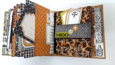 an open book with many different designs and words on the pages, all in black and orange