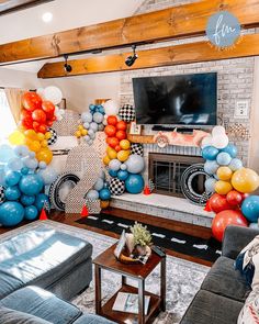 a living room filled with balloons and a television