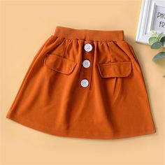 Girls Solid Color Elastic Waist Button Skirt Wholesale Girl Boutique Clothing - PrettyKid Jumpsuit For Kids, Girls Boutique Clothing, Houndstooth Skirt, Skirt Fabric, Skirts For Kids, Button Skirt, Online Clothing Boutiques, Girls Boutique, Affordable Clothes