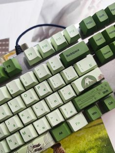 a green and white keyboard sitting on top of a table