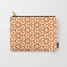 an orange and white pattern with leaves on it carry - all pouch bag by artfuldesign