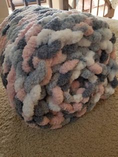 a pile of yarn sitting on top of a carpet