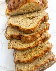 slices of banana bread stacked on top of each other in front of a marble countertop