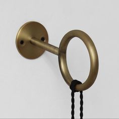 an image of a door handle that is on the side of a wall with black beads hanging from it