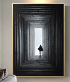 a person standing in the middle of a room with a black and white photo on the wall