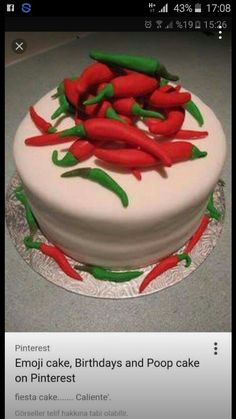 a white cake topped with red and green chili peppers