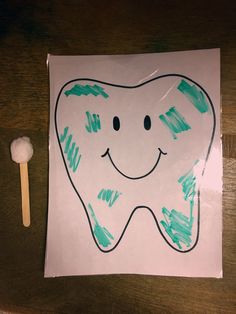 a drawing of a tooth with a smile on it and a toothbrush next to it