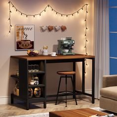 a table with two stools in front of it and some lights on the wall