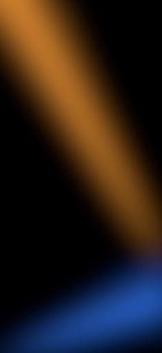 a blurry image of an orange and blue line on a black background is shown