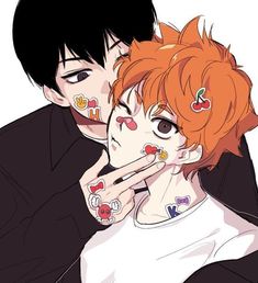 two people with their faces covered in stickers, one is kissing the other's cheek