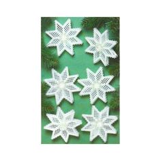 crocheted snowflakes are arranged on a green background