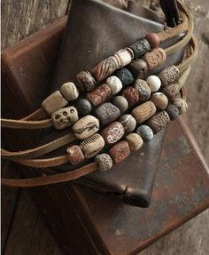 a bunch of rocks sitting on top of a brown leather bag next to a wallet