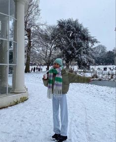 a woman standing outside in the snow