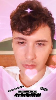 a young man wearing a white shirt and pink bow tie