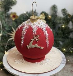 a red ornament sitting on top of a white plate