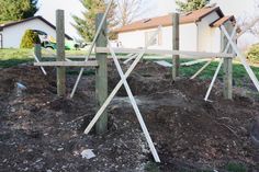 a wooden structure sitting on top of a pile of dirt