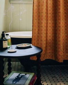 a bath room with a tub and a table