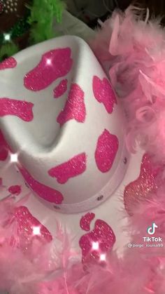 a white hat with pink glitter hearts on it