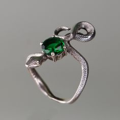 925 Silver Snake Emerald Ring,  925 Sterling Silver Ring, Emerald Snake Silver Ring, Emerald Snake Silver Ring, Animal Snake Jewelry Let's not forget that it is handmade. There may be minor differences. I can work the same ring with other natural Gemstones.  Please contact us to learn about our Gem stone stocks. If you have any questions, please feel free to contact me, we are happy to help. Your jewelry will be packed in a luxury jewelry box ready to be given as a special gift. Visit my shop to Green Snake Ring For Gift, Green Snake Ring Gift, Unique Sterling Silver Snake Ring As Gift, Symbolic Hand Forged Sterling Silver Rings, Unique Hand Cast Snake Ring As Gift, Sterling Silver Hallmarked Snake Ring Gift, Unique Hand Cast Snake Ring Gift, Silver Sterling Silver Snake Ring, Silver Gemstone Snake Ring For Gift