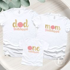 two t - shirts with the words mom and daughter printed on them next to a plant