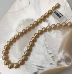 "Beautiful 8-10mm Golden South Sea Cultured Pearl of Natural Color Strand. Strand has high luster, with slight birth marks and well matched. Take advantage of this unique opportunity. You can choose between Rhodium plated 925 Silver clasp or 18k Gold plated 925 Silver clasp, real solid silver not gold filled! If you would like a Certificate of Authenticity included with your order please message us. Pearl Type: Cultured Golden South Sea Pearl Color: All Natural Gold, High Luster with slight birt Classic Polished Beads Pearl Necklace, Classic Pearl Necklace With Polished Beads, Classic Round Pearl Necklace With Polished Beads, Formal Polished Pearl Necklace, High Luster Round Akoya Pearl Necklace, Classic Gold Pearl Necklace With 8mm Beads, High Luster Round Beads Pearl Necklace For Anniversary, High Luster Round Pearl Necklace For Anniversary, Anniversary Pearl Necklace With High Luster Round Beads