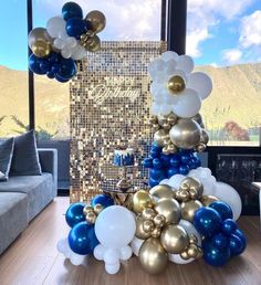 balloons and confetti are arranged on the floor in front of a large window