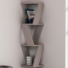 a corner shelf with three shelves on the wall