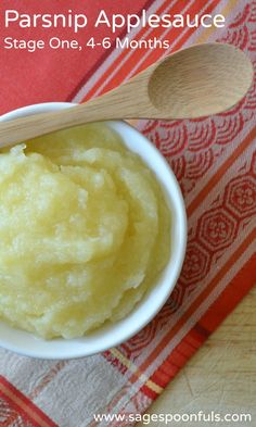 mashed parsnip applesauce in a white bowl with wooden spoon