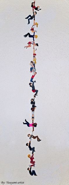 a group of people standing in the shape of a long line on top of each other