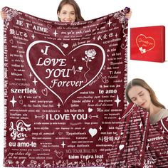 a woman is holding up a blanket with the words i love you forever