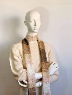 Elevate your winter ensemble with our Handmade Knit Scarf, meticulously crafted to add warmth and style to your wardrobe. This charming accessory features a blend of neutral beige and brown tones, intertwined with soft caramel, light pink, and brown shades, creating a captivating striped pattern. 🧣 Skinny Scarf Design: Embrace chic simplicity with our slim and stylish knit scarf design. Perfect for layering, this long striped scarf tie offers versatility in styling, whether loosely draped or el