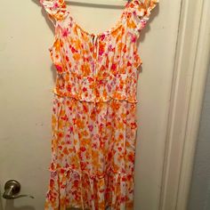 Never Worn White Dress With Colorful Flowers Of Oranges, Pinks, And Yellows. This Dress Is In A Size Large. White Floral Sundress With Ruffles, White Floral Ruffled Dress For Beach, White Floral Dress With Ruffles For Beach, White Ditsy Floral Print Dress For Vacation, White Floral Print Sundress For Vacation, White Floral Dress With Ditsy Print For Vacation, White Sundress With Ditsy Floral Print, White Ditsy Floral Print Dress, White Floral Print Summer Dress