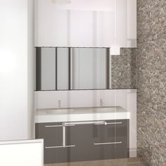 an empty bathroom with stone walls and white counter tops, along with a large mirror on the wall