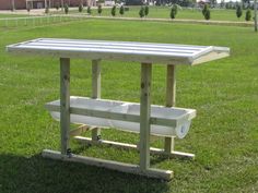 a picnic table with two coolers on it in the grass