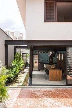 an open living room and dining area in a modern house with large sliding glass doors