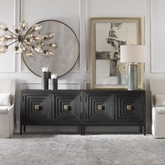 a living room filled with furniture and a chandelier hanging from the sideboard