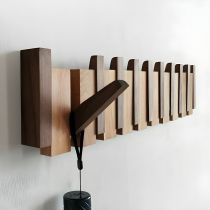 a wall mounted shelf with a lamp and some sort of hook on the wall next to it