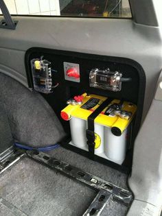 two batteries in the back of a car