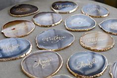 there are many different types of seashells on the table with name written on them