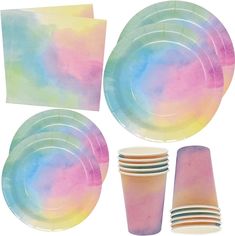 a set of paper plates, cups and napkins with pastel colors on them